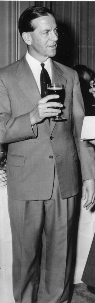 Father Desmond, drinking Guinness