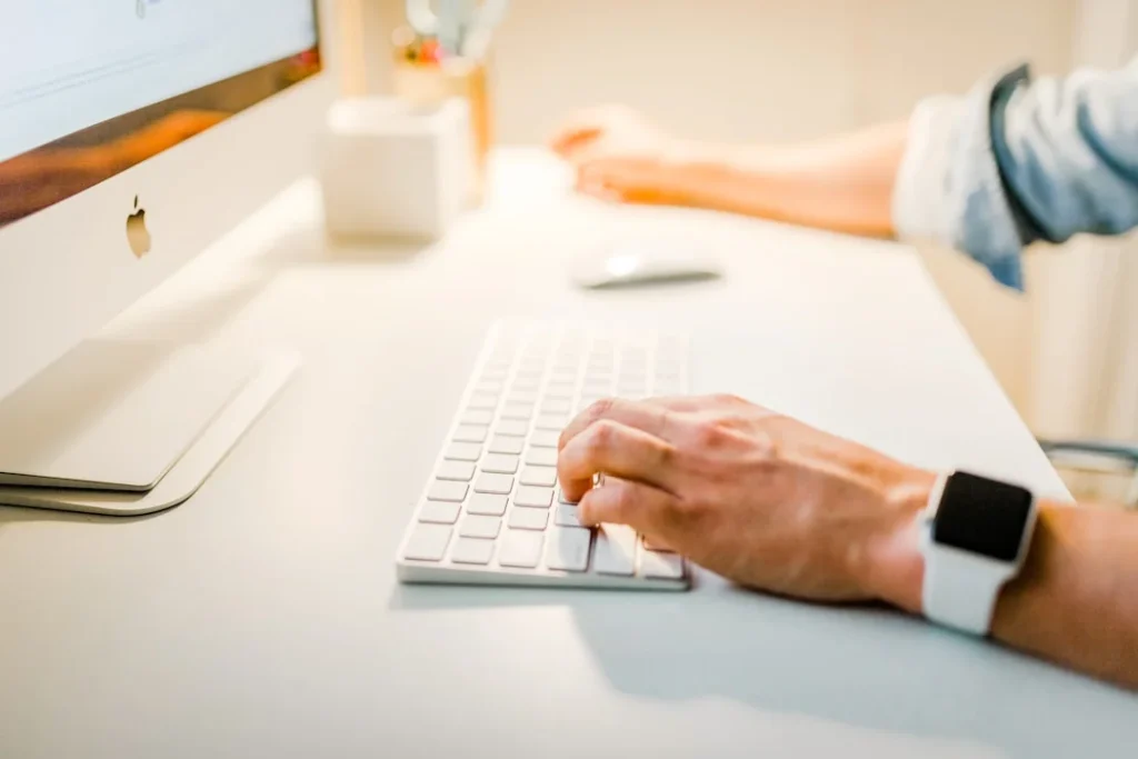 A person typing on a computer keyboard, illustrating key features of Salesforce for effective account planning.